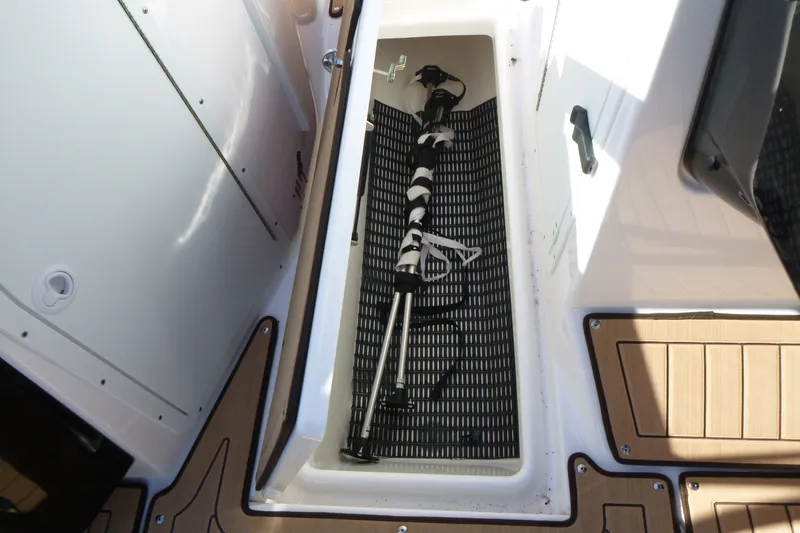 Slide: The Image of 2023 Yamaha Boats 222SD storage compartment with equipment inside. - 13