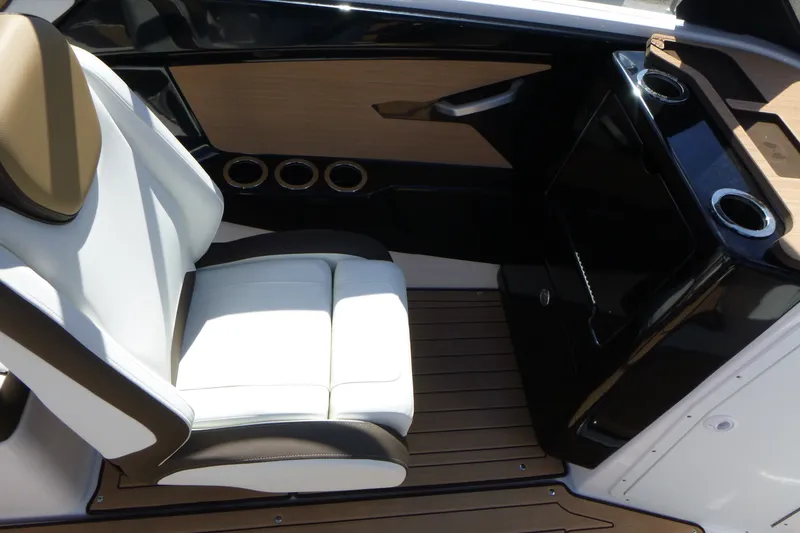 Slide: The Image of 2023 Yamaha Boats 222SD interior with white seating and sleek black console design. - 11