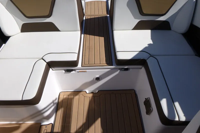Slide: The Image of 2023 Yamaha Boats 222SD interior with white seating and teak flooring. - 12