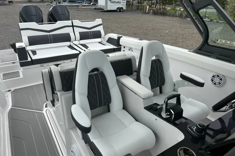 Slide: The Image of Luxury interior of 2027 Monterey Elite 30 OB boat with plush seating and modern controls. - 14