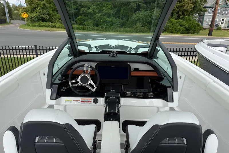 Slide: The Image of 2027 Monterey Elite 30 OB boat cockpit with modern steering and dashboard controls. - 16