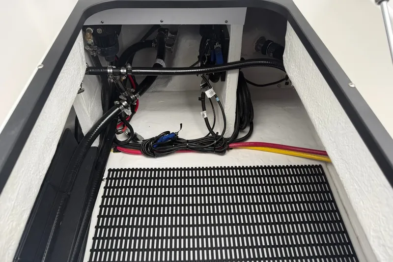 Slide: The Image of Engine compartment of a 2027 Monterey Elite 30 OB boat, showcasing wiring and hoses. - 26