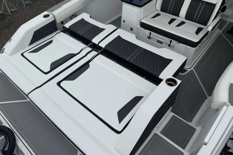 Slide: The Image of 2027 Monterey Elite 30 OB boat interior with sleek, modern seating and cup holders. - 23