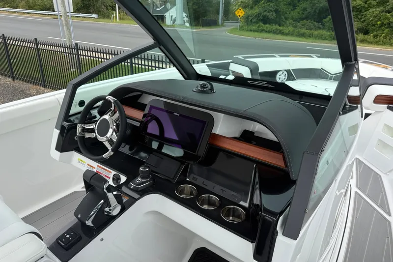 Slide: The Image of 2027 Monterey Elite 30 OB boat dashboard with modern steering and touchscreen display. - 15