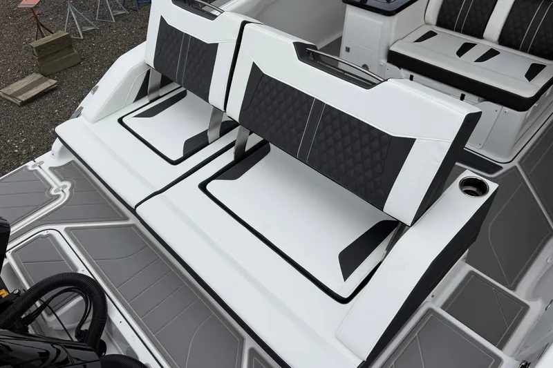 Slide: The Image of Luxury seating on 2027 Monterey Elite 30 OB boat, featuring sleek black and white design. - 22