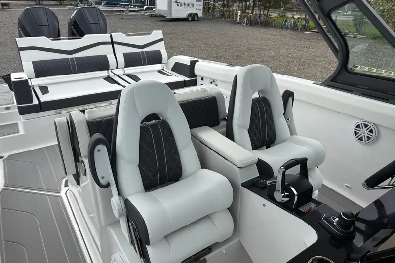 Slide: The Image of Luxurious interior of 2027 Monterey Elite 30 OB boat with plush seating and modern controls. - 13