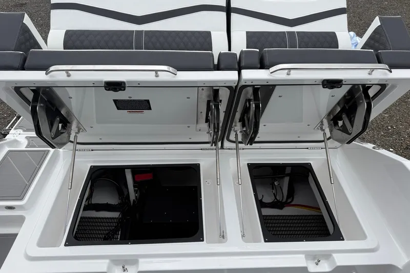 Slide: The Image of 2027 Monterey Elite 30 OB boat storage compartments open, showcasing interior design and functionality. - 24