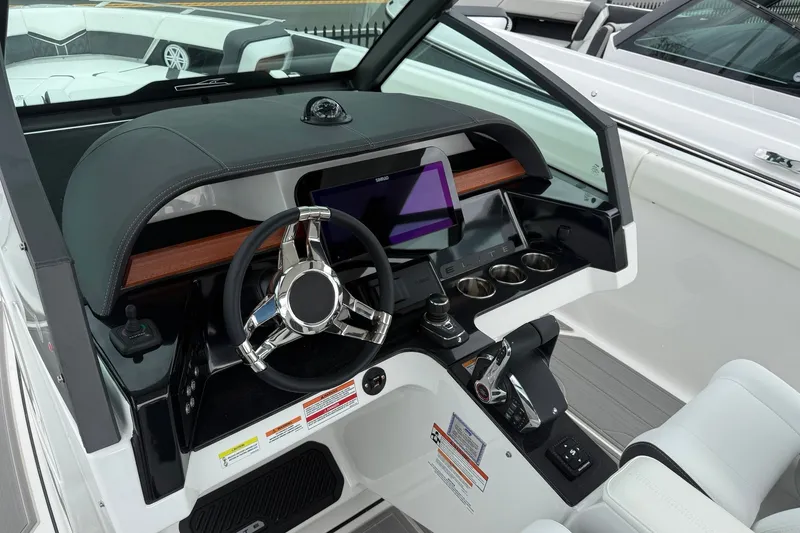 Slide: The Image of Cockpit of 2027 Monterey Elite 30 OB boat with modern steering and controls. - 17