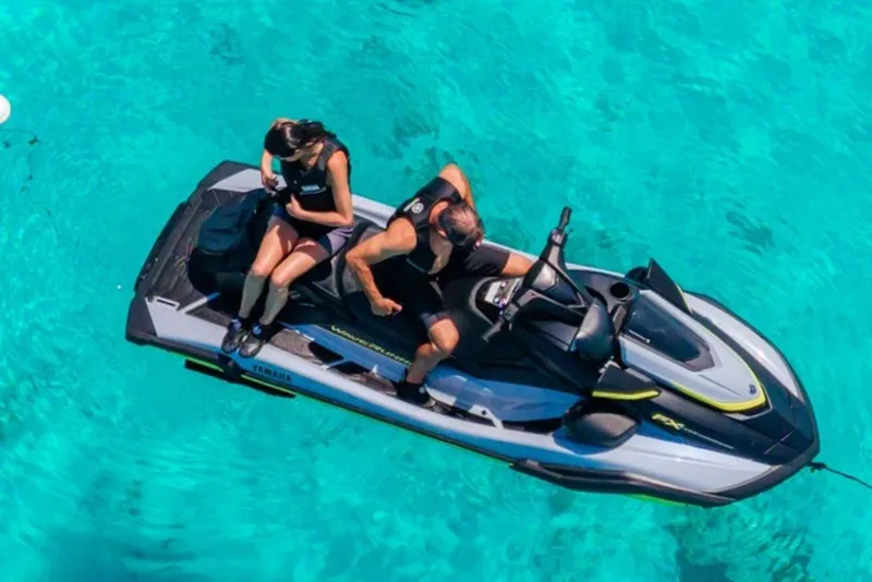 Slide: The Image of 2027 Yamaha WaveRunner FX SVHO on clear turquoise water with two riders. - 7