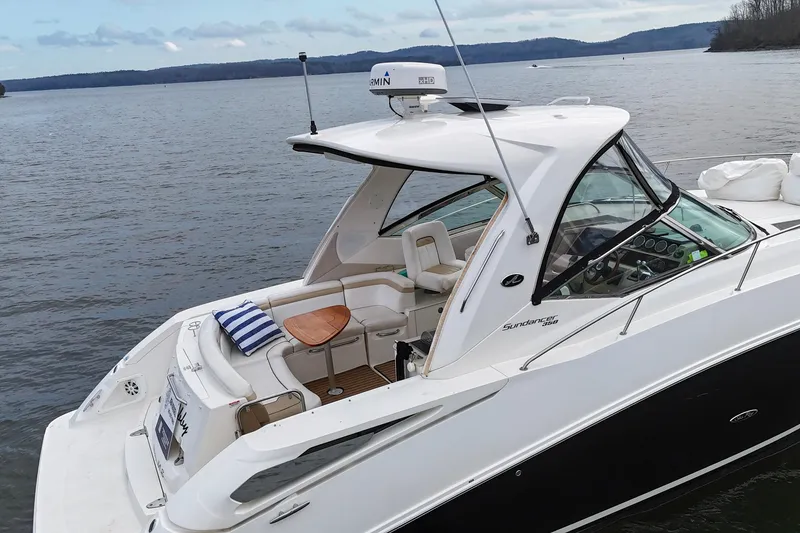 Slide: The Image of 2009 Sea Ray Sundancer 350 yacht on calm lake with scenic background. - 9