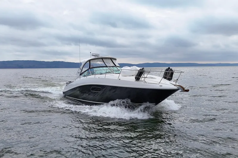 Slide: The Image of 2009 Sea Ray Sundancer 350 cruising on open water under cloudy skies. - 1