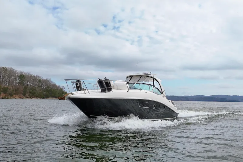 Slide: The Image of 2009 Sea Ray Sundancer 350 cruising on a scenic lake under cloudy skies. - 13