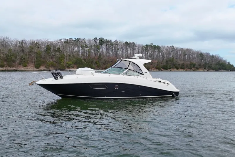 Slide: The Image of 2009 Sea Ray Sundancer 350 yacht on a calm lake with wooded shoreline. - 11