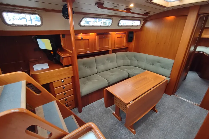 Slide: The Image of Luxurious 2005 Hallberg-Rassy 43 yacht interior with wood finish and cozy seating area. - 42