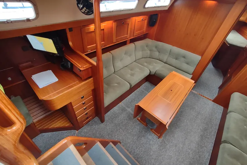 Slide: The Image of Interior of 2005 Hallberg-Rassy 43 yacht with wooden furnishings and cozy seating area. - 35