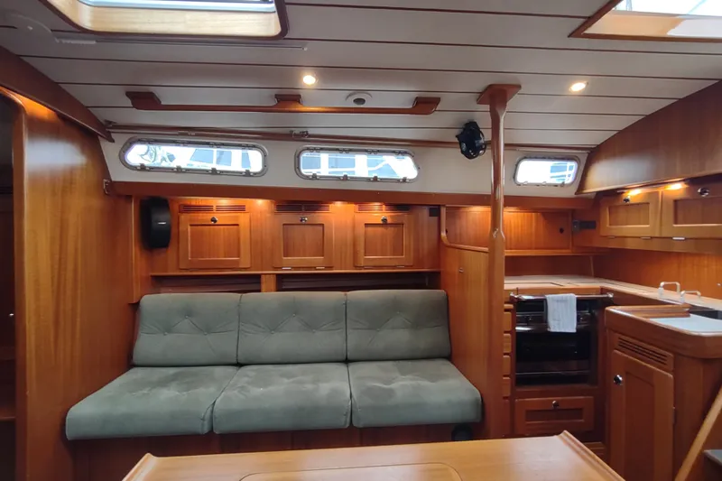 Slide: The Image of Luxurious 2005 Hallberg-Rassy 43 yacht interior with wood finish and comfortable seating. - 39