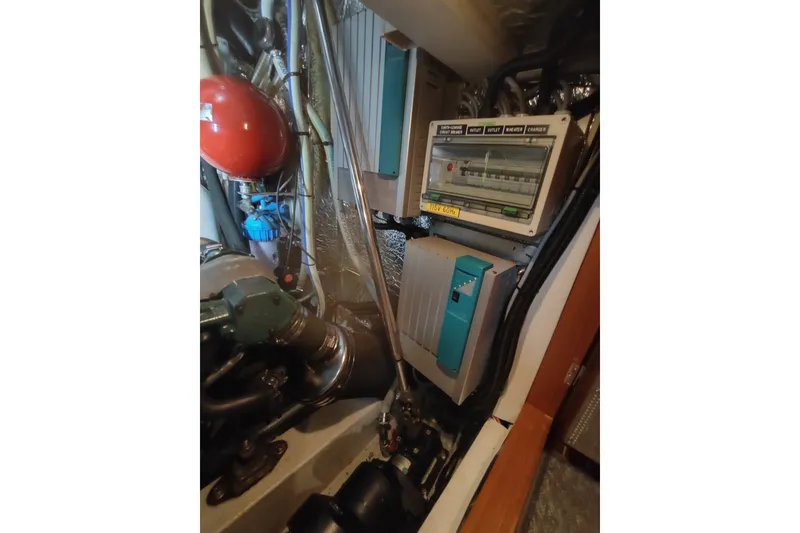 Slide: The Image of Engine room of a 2005 Hallberg-Rassy 43 yacht, featuring control panels and equipment. - 61