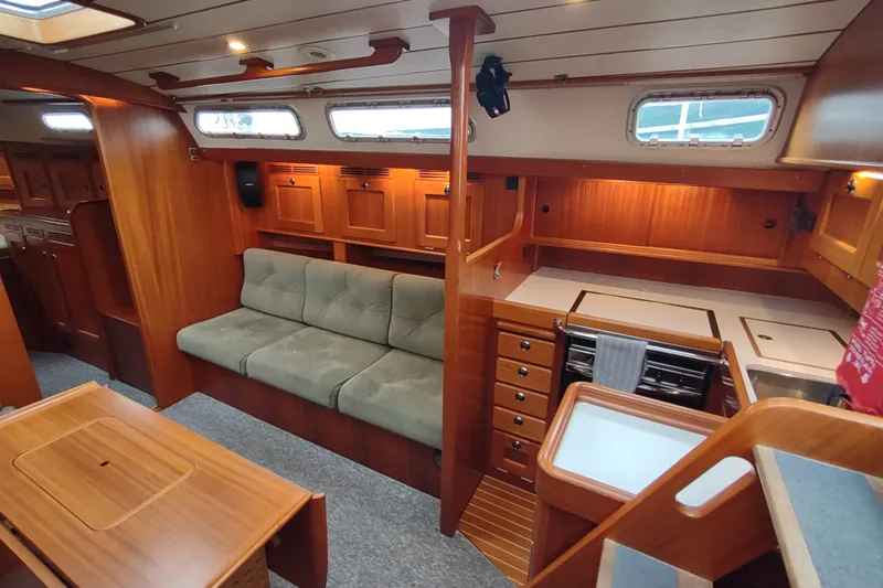 Slide: The Image of Interior of 2005 Hallberg-Rassy 43 yacht with wooden cabinetry and cozy seating area. - 38