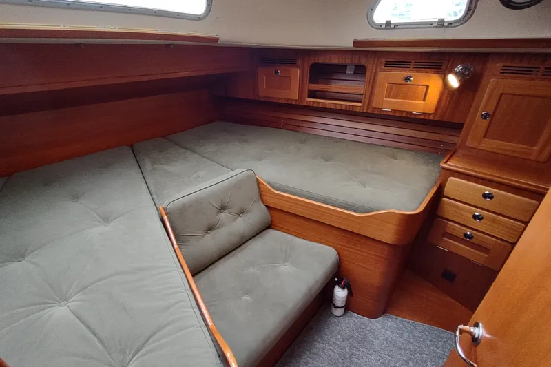 Slide: The Image of Cozy cabin interior of 2005 Hallberg-Rassy 43 yacht with wooden finish and cushioned seating. - 58