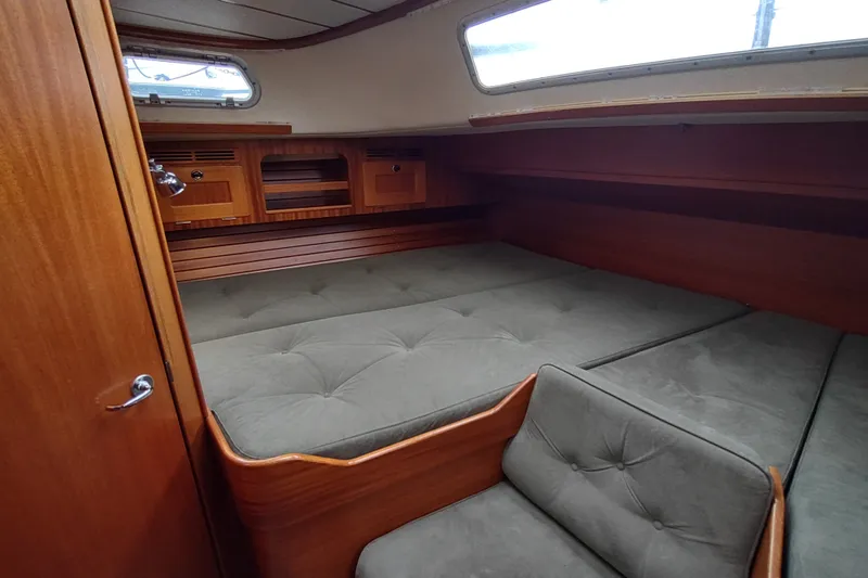 Slide: The Image of Luxurious 2005 Hallberg-Rassy 43 yacht cabin with plush bedding and wooden interior. - 55