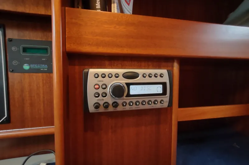 Slide: The Image of Control panel and stereo system inside a 2005 Hallberg-Rassy 43 yacht cabin. - 65