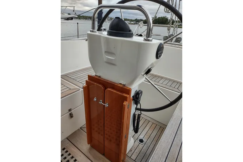 Slide: The Image of Steering wheel and console of 2005 Hallberg-Rassy 43 sailboat, featuring wooden accents. - 29