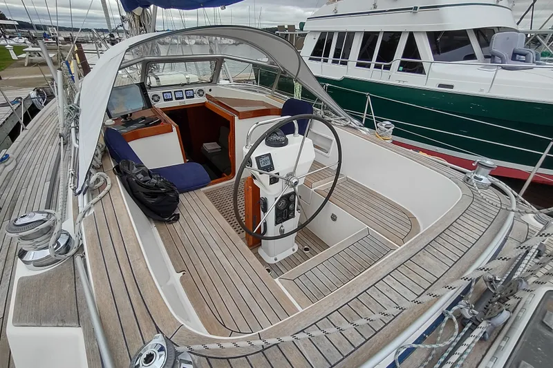 Slide: The Image of Cockpit of 2005 Hallberg-Rassy 43 sailboat with wooden deck and steering wheel. - 25