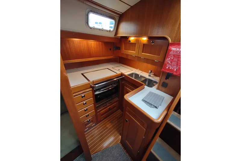 Slide: The Image of Interior of 2005 Hallberg-Rassy 43 yacht kitchen with wood cabinetry and modern appliances. - 52