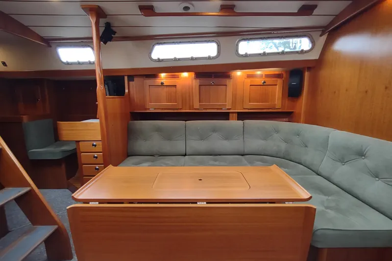 Slide: The Image of Interior of 2005 Hallberg-Rassy 43 yacht with wooden furnishings and cushioned seating. - 40