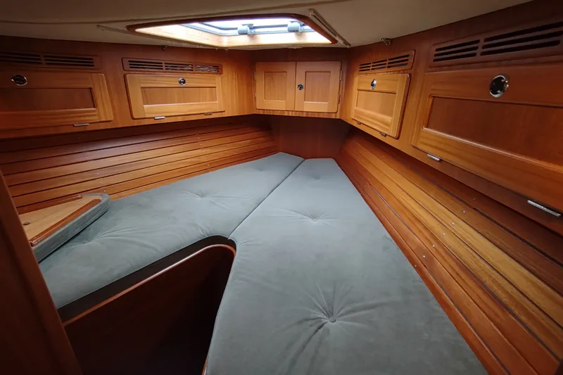 Slide: The Image of Cozy cabin interior of 2005 Hallberg-Rassy 43 sailboat with wooden paneling and skylight. - 46