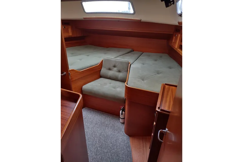 Slide: The Image of Interior of 2005 Hallberg-Rassy 43 yacht with cozy wooden cabin and cushioned seating. - 53