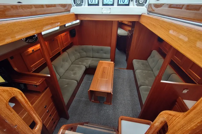Slide: The Image of Luxurious 2005 Hallberg-Rassy 43 yacht interior with plush seating and wooden finishes. - 34