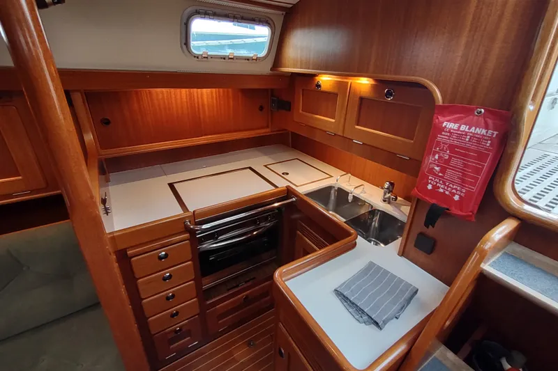 Slide: The Image of Interior of 2005 Hallberg-Rassy 43 yacht kitchen with wood cabinetry and stainless steel sink. - 49