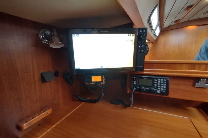 Slide: The Image of Navigation equipment inside a 2005 Hallberg-Rassy 43 yacht cabin. - 63