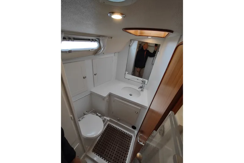 Slide: The Image of Bathroom interior of 2005 Hallberg-Rassy 43 yacht, featuring sink, toilet, and mirror. - 47