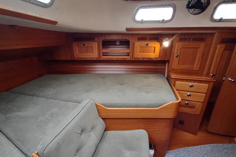 Slide: The Image of Interior cabin of 2005 Hallberg-Rassy 43 yacht with wooden finish and cozy seating. - 56