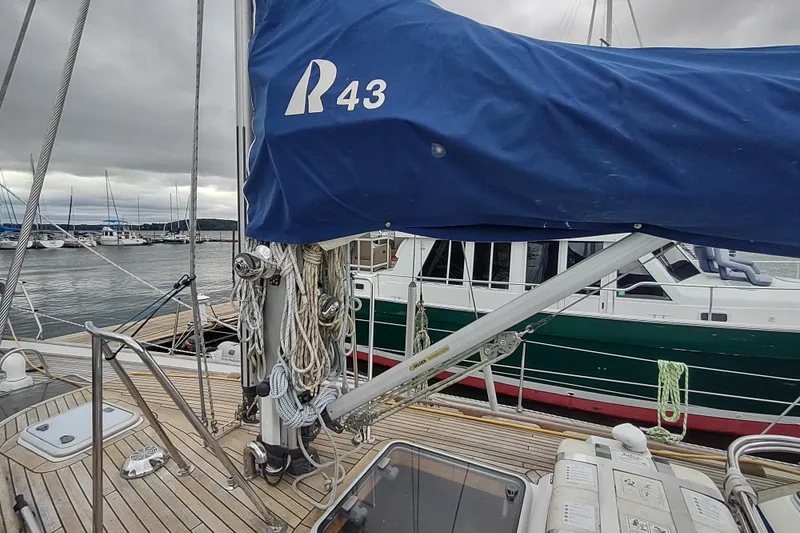 Slide: The Image of Deck view of a 2005 Hallberg-Rassy 43 sailboat in a marina. - 17
