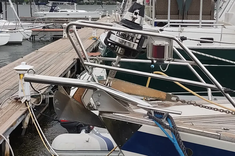 Slide: The Image of Bow of a 2005 Hallberg-Rassy 43 yacht docked at a marina. - 13