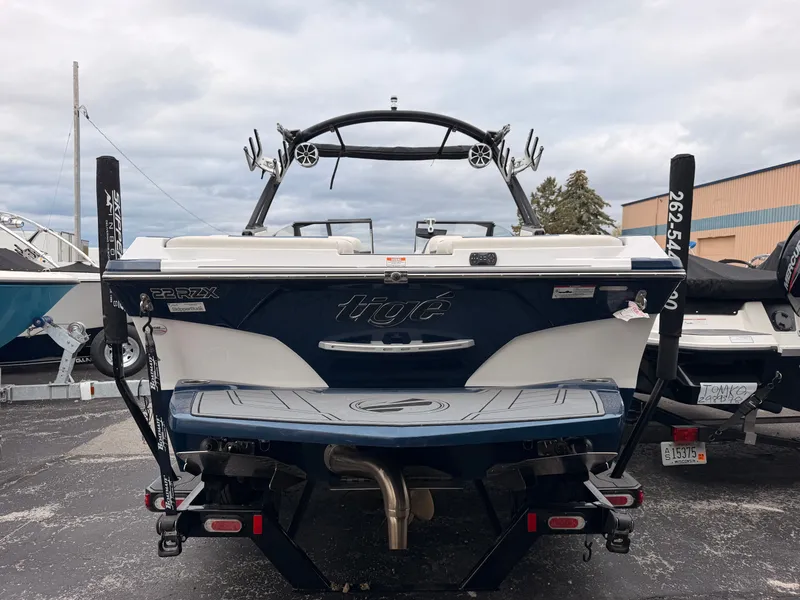 Slide: The Image of The image shows the rear of a 2021 Tigé 22RZX boat with a sturdy tower and speakers. - 4