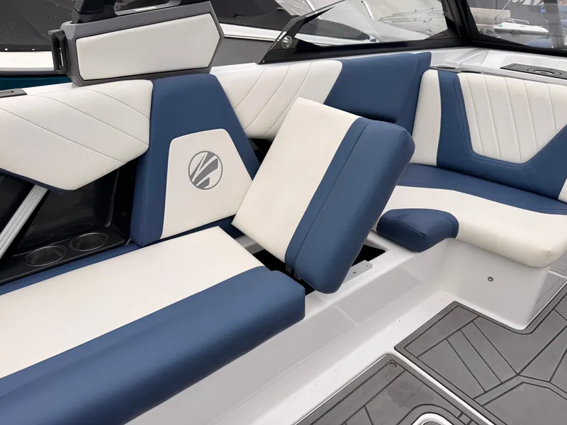 Slide: The Image of The image shows the luxurious interior of a 2021 Tigé 22RZX with blue and white seating. - 26