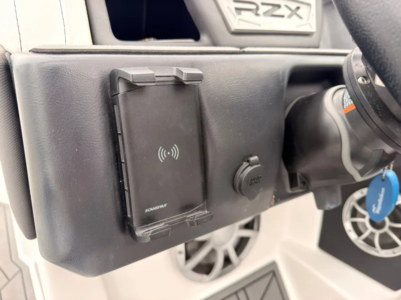 Slide: The Image of Close-up of a 2021 Tigé 22RZX dashboard with charger and speaker. - 39