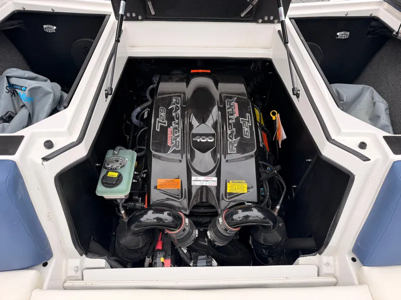 Slide: The Image of The engine compartment of a 2021 Tigé 22RZX with a powerful engine and well-organized components. - 16