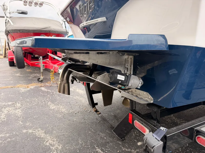 Slide: The Image of The image shows the rear of a blue 2021 Tigé 22RZX boat with a trailer. - 7