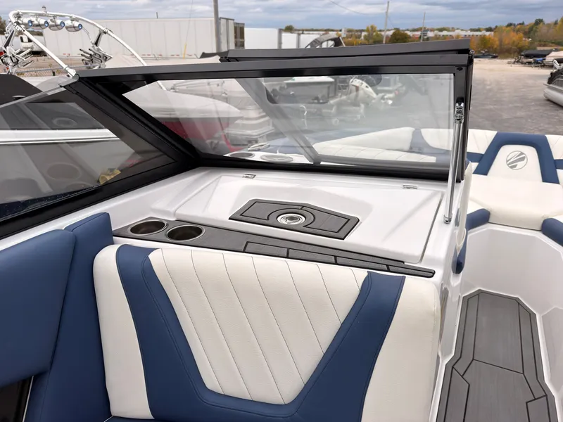 Slide: The Image of The image shows the cockpit of a 2021 Tigé 22RZX boat with blue and white seating. - 34