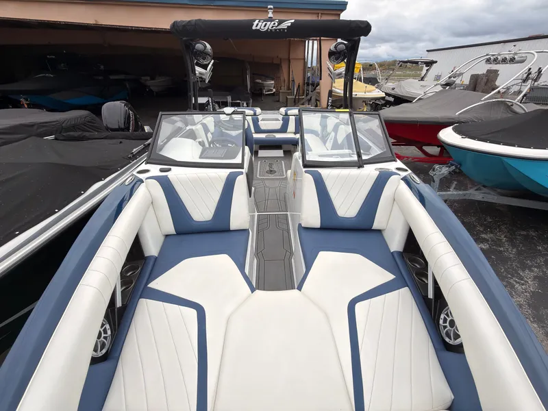 Slide: The Image of The image shows the interior of a 2021 Tigé 22RZX boat with blue and white seating. - 48