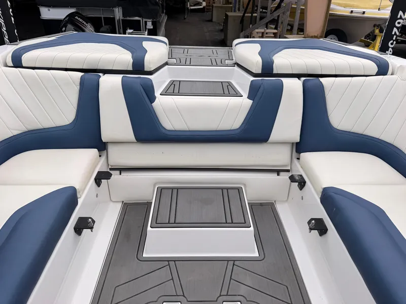 Slide: The Image of The image shows the interior of a 2021 Tigé 22RZX boat with blue and white seating. - 22