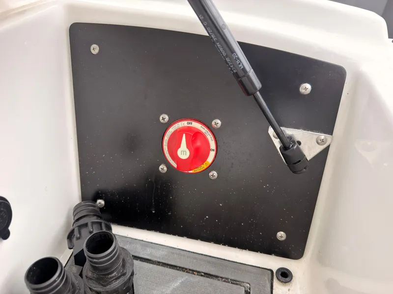 Slide: The Image of Close-up of a boat component with a red switch and black connectors. - 36