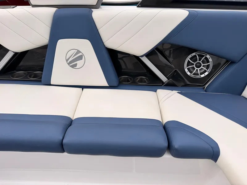 Slide: The Image of The 2021 Tigé 22RZX features stylish blue and white upholstery with speakers and cup holders. - 25