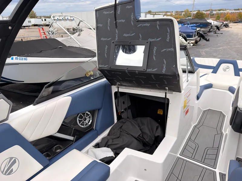 Slide: The Image of The image shows the interior of a 2021 Tigé 22RZX boat with blue and white seating. - 31