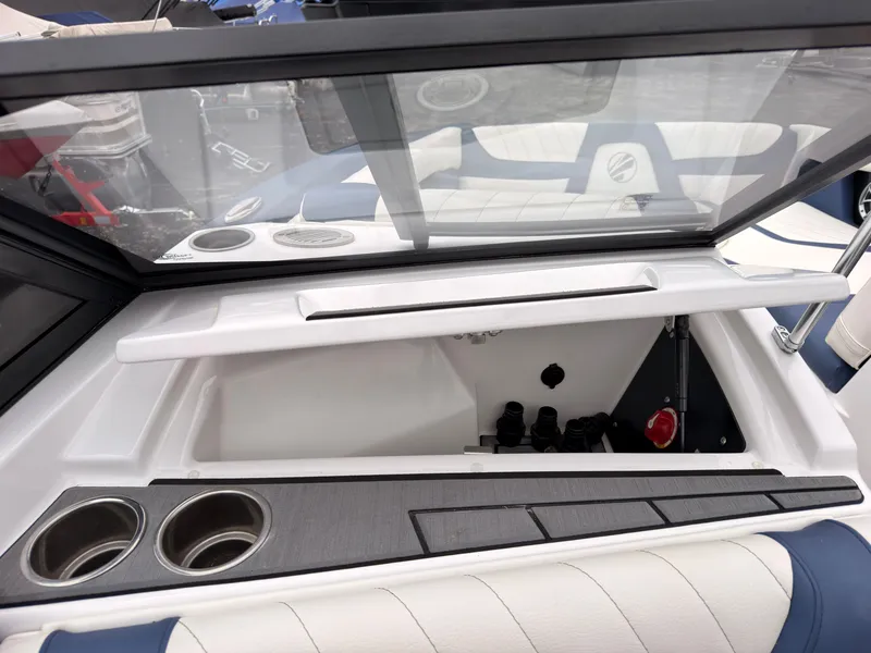 Slide: The Image of The image shows the interior of a 2021 Tigé 22RZX boat with cup holders and storage space. - 35